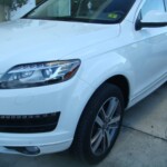 Before and after photographs of a damaged white, AUDI Quattro SUV that was repaired by Elite Paint & Body Shop in West Palm Beach, Florida.